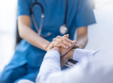 Cropped shot of a female nurse hold her senior patient's hand. Giving Support. Doctor helping old patient with Alzheimer's disease. Female carer holding hands of senior man